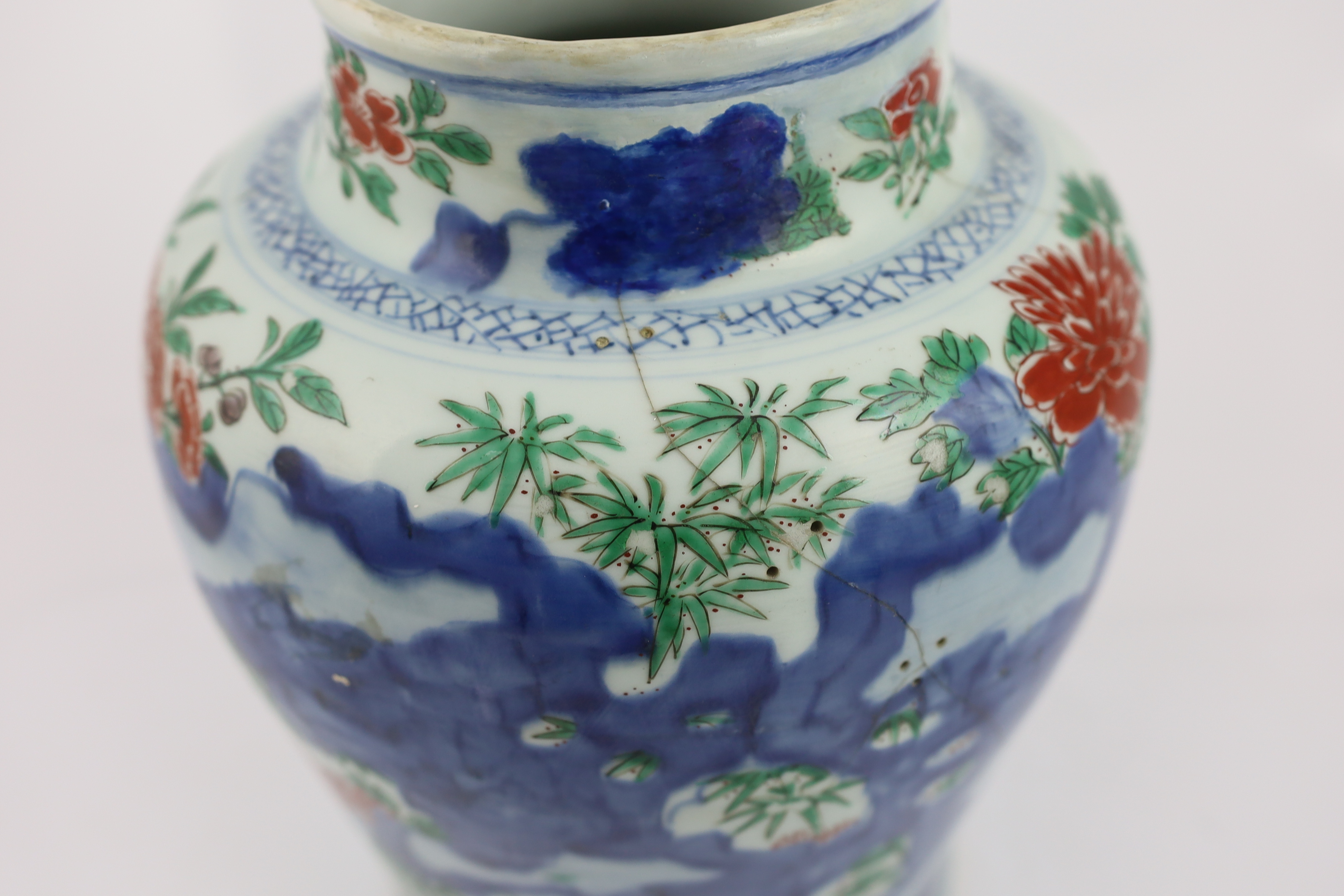 A Chinese wucai ‘rocks and blossom’ vase, Transitional, Shunzhi period, cracked and restoration to neck